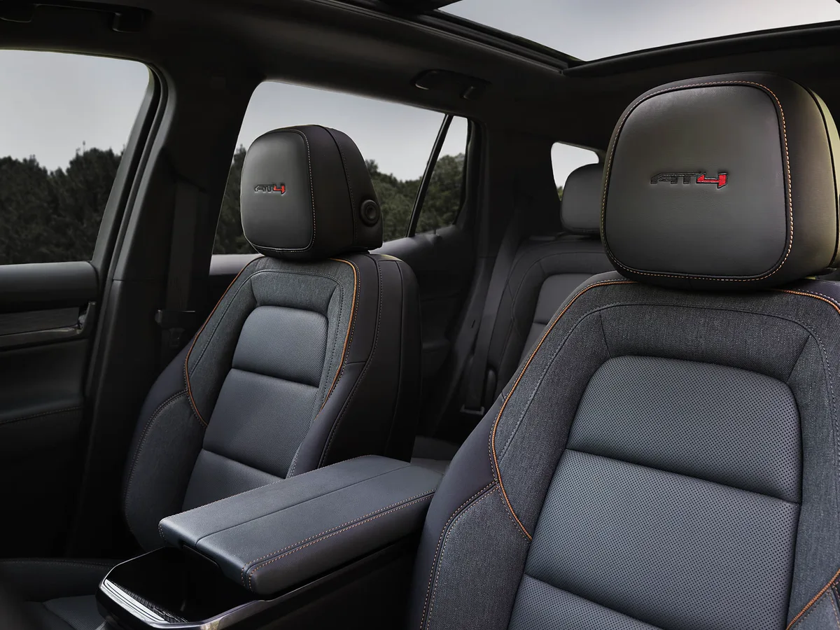 GMC Interior Featuring Dark Gray AT4 Front Seats with Orange Stitching and a Panoramic Sunroof
